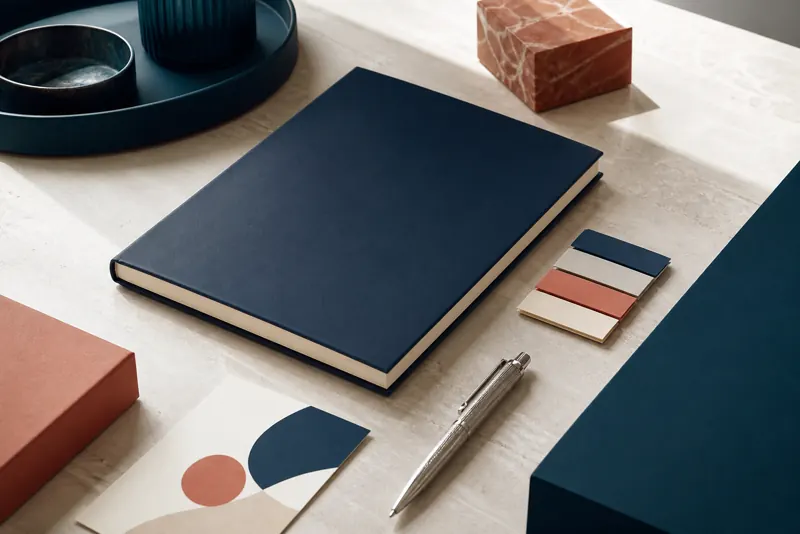 Notebook e penna su scrivania con campioni coordinati
